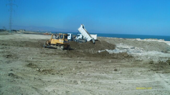 Bulldozer leveling the clean soil