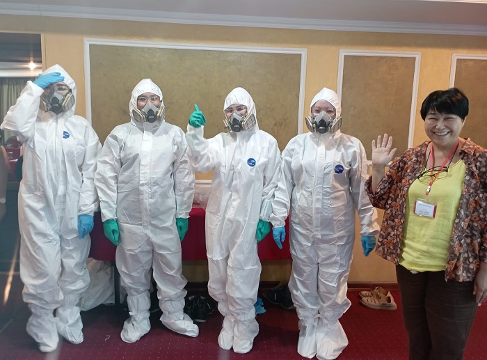 Trainees wearing protective suits for contaminated-site fieldwork.