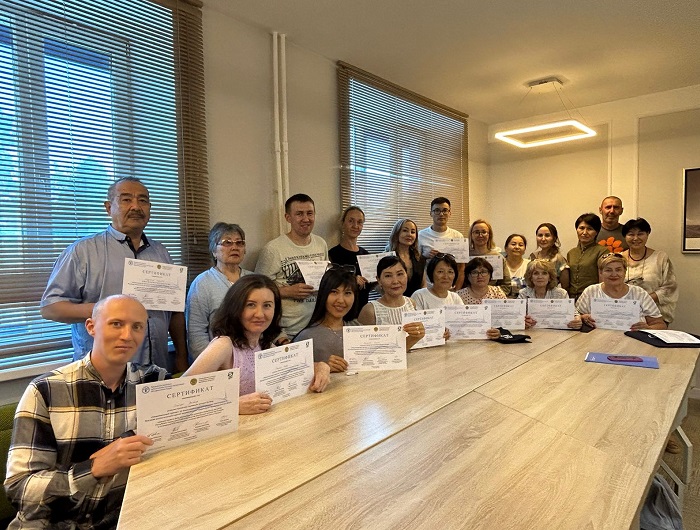 Participants holding certificates after contaminated-site assessment training.